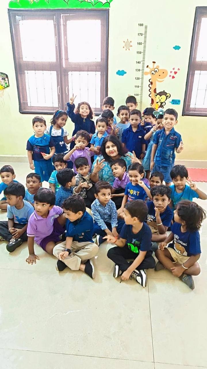 Children and their teacher dressed in blue for Color Day