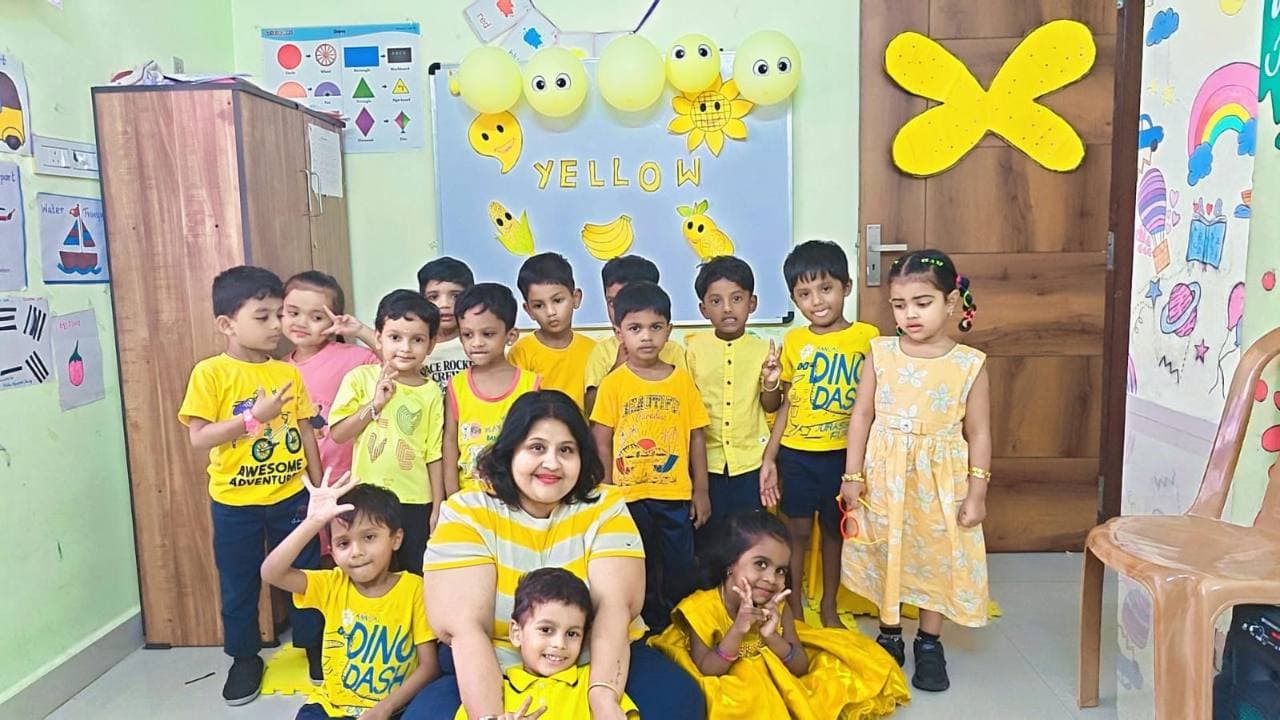 Children and their teacher dressed in yellow for Color Day