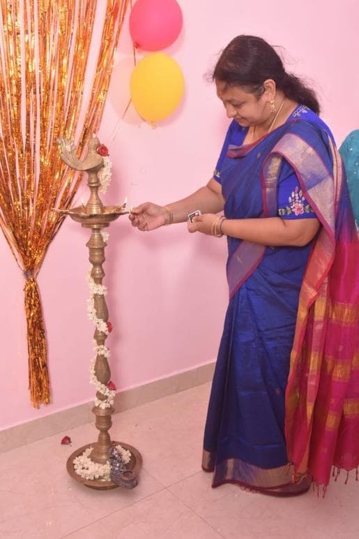 A member of the Littlelings team lighting a traditional lamp at the inauguration